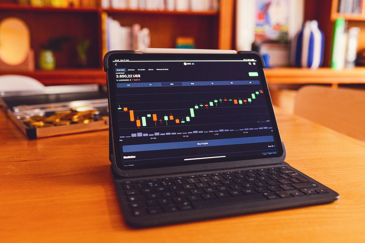 Trader analyzing market trends with a laptop